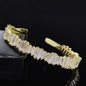 Detail of S925 sterling silver gold-plated cuff with baguette-cut sparkling crystals