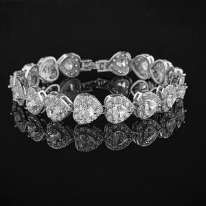 Macro view of 18K silver-plated heart-shaped links with sparkling zircon stones