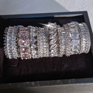 Macro detail of silver rings set with emerald, oval, and pear cut zircon crystals