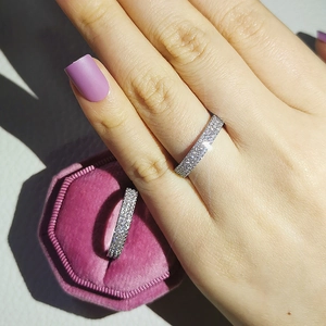 Detail of luxury zircon paved silver ring with elegant hexagonal pink velvet jewelry box