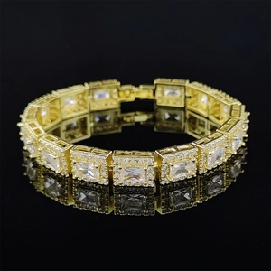 Macro shot of 18K gold plated bracelet with square cut zircons on reflective black base