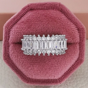 Macro view of wide silver band ring with rectangular and round cubic zirconia stones