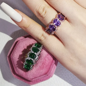 Detail of rose gold purple and silver green oval cut cubic zirconia eternity rings