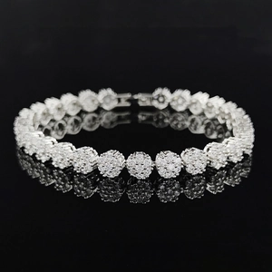 Detailed macro view of 18K gold plated silver tennis bracelet with cubic zirconia flowers