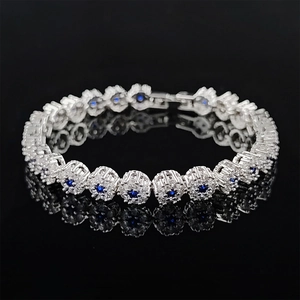 Y2K style silver bracelet featuring round blue gemstones and micro-pave diamond halo
