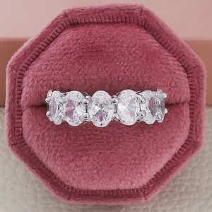 Macro shot of silver five-stone oval-cut zircon ring in a pink velvet jewelry box