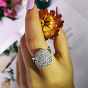 Luxurious silver pavé dome ring encrusted with sparkling clear zircons on a hand
