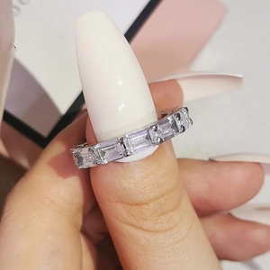 Close-up of emerald cut eternity ring with sparkling crystals on a hand