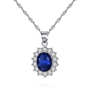 Elegant silver necklace featuring oval blue gemstone pendant with white zircon halo on white background