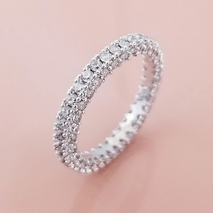 Macro shot of a luxury triple-row full zircon micro-pave eternity ring in silver finish