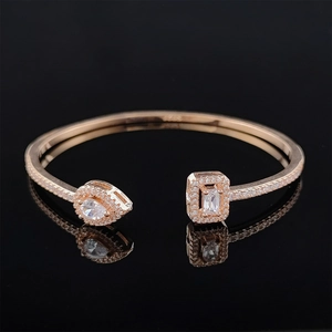 Macro shot of S925 rose gold bracelet with halo-set pear and rectangle cut crystals