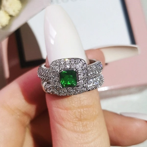 Close-up of luxury emerald cut green stone ring set with micro-pave cubic zirconia
