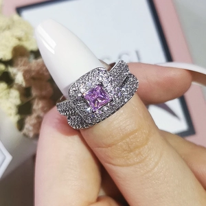 Close-up of a luxury silver-tone ring set featuring a large square purple gemstone