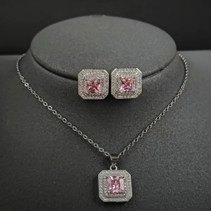 Detailed view of pink princess cut jewelry set with square pendant and stud earrings