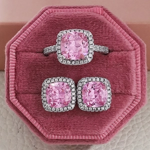 Pink cushion-cut gemstone jewelry set with halo ring and stud earrings in box