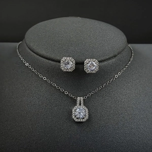 Detail view of square cut moissanite pendant necklace and stud earrings set