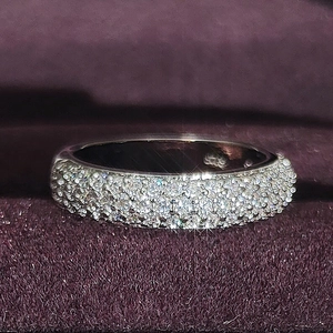 Luxury wide band ring with shimmering pavé diamond setting in a purple velvet gift box