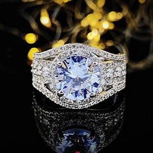 Macro shot of luxury halo ring with light blue center stone and pave diamond accents