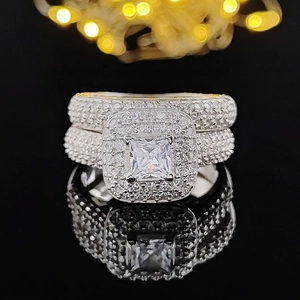 Luxury silver bridal ring set with large square-cut main stone and micro-paved diamonds