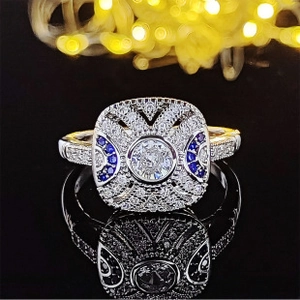 Macro view of micro-pave princess ring with blue gemstones and vintage silver finish