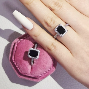 Macro detail of luxury rectangular black gemstone ring with pavé zircon setting