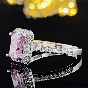Macro view of S925 silver ring featuring a large emerald-cut pink gemstone and pavé zircon