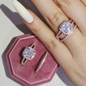 Vista macro de conjunto de anillos de oro rosa con circonitas en joyero de terciopelo