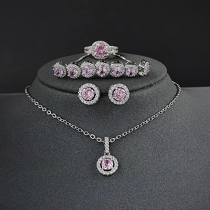 Elegant 4-piece jewelry set with pink round halo crystals in silver-toned setting