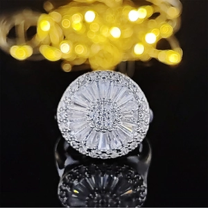 Luxurious sunburst zircon ring with radiant baguette stones on silver metal band