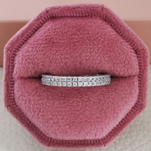 Close-up of double row crystal ring in a pink velvet octagon jewelry box