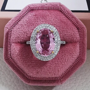 Elegant oval pink cubic zirconia ring with double halo pavé setting in a velvet box