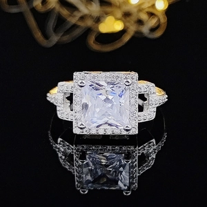 Luxurious square halo ring featuring a large princess cut stone and gold accents