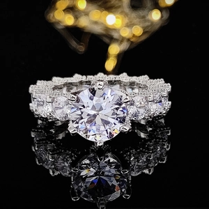 Silver vintage ring with large round solitaire and pave diamonds on black mirror