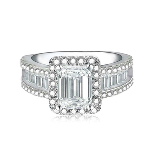 Elegant silver ring with emerald cut clear zircon and halo stones on white background