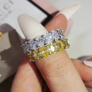 Close-up of eternity bands with oval-cut white and yellow cubic zirconia stones