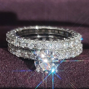 Sparkling silver round zircon ring set with main stone and pavé band in purple box