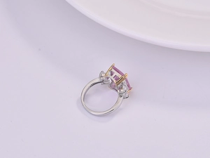 Close-up of luxury rectangular pink crystal ring with 18K gold plated four-claw setting