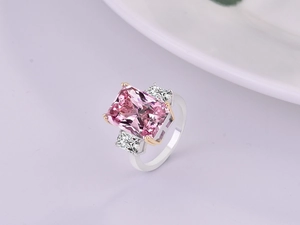 Macro view of luxury three-stone ring with rectangle pink crystal and silver plated band