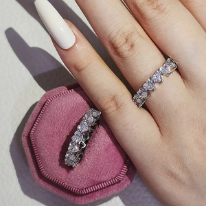 Elegant heart-shaped eternity ring with white cubic zirconia in a pink velvet box