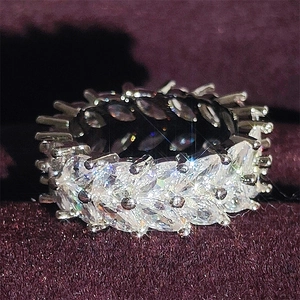 Macro shot of marquise-cut cubic zirconia eternity ring on a purple velvet background