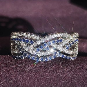 Exquisite braided double-row ring with white zircons and deep blue gemstones in silver finish