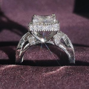 Luxury square cut diamond ring with halo setting in a purple velvet jewelry display box