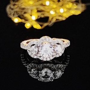 Drei-Steine-Zirkonia-Ring mit Pavé-Diamanten auf schwarzer, reflektierender Fläche