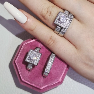 Close-up of sparkling square-cut zircon engagement ring set on a pink velvet jewelry box