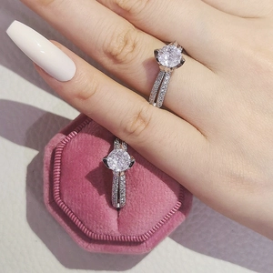 Close-up of two vintage silver rings with round brilliant-cut diamonds and pave setting