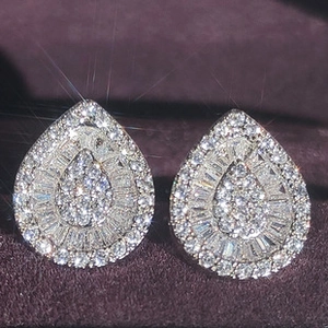 Macro de pendientes de gota en plata con circonitas pavé en un estuche de joyas morado