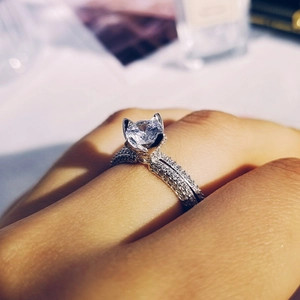 Macro shot of a cat ear shaped halo ring with a round center diamond and pave band