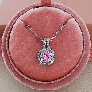 Elegant silver necklace with square halo pendant featuring a large round pink zircon stone