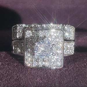Luxury square pave set wedding ring set with brilliant round main stone on purple velvet