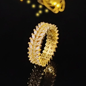 Detailed close-up of gold eternity ring featuring marquise-cut sparkling gemstones